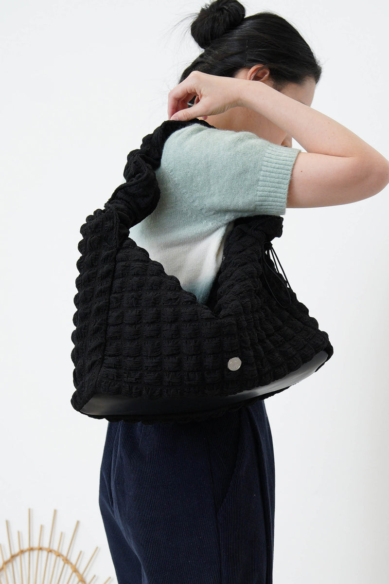 Black texture shoulder bag in elastic handle