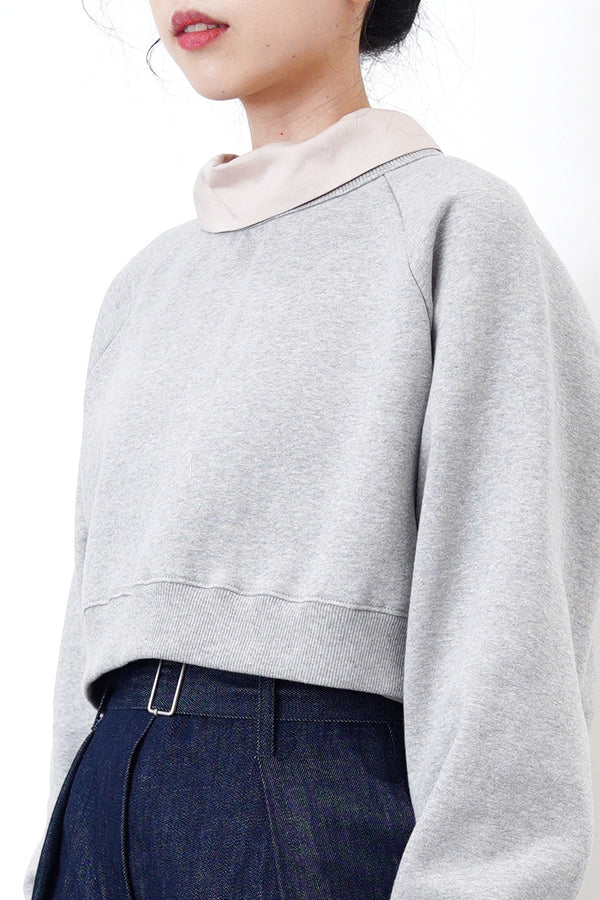 Grey crop cut pullover in stepped hem