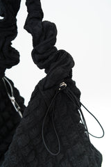 Black texture shoulder bag in elastic handle