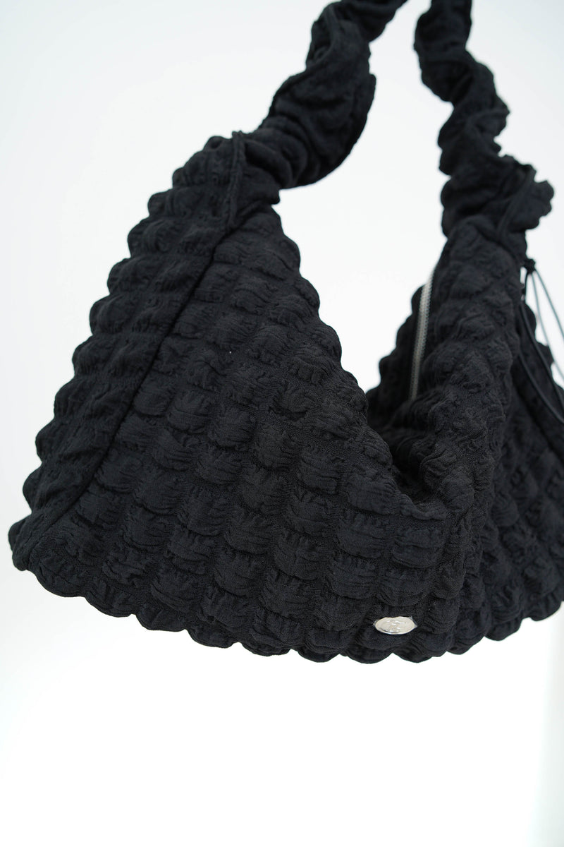 Black texture shoulder bag in elastic handle