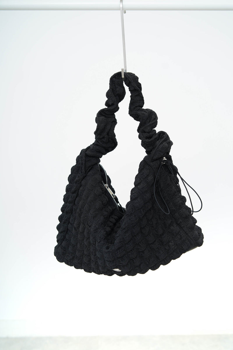 Black texture shoulder bag in elastic handle
