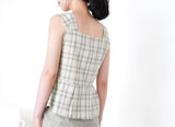 Green checked vest in peplum hem