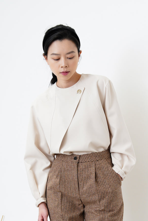 Nude satin blouse in asymmetrical cutting