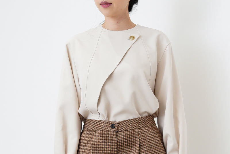Nude satin blouse in asymmetrical cutting