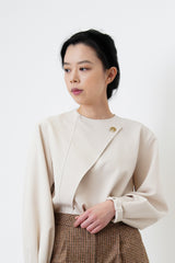 Nude satin blouse in asymmetrical cutting