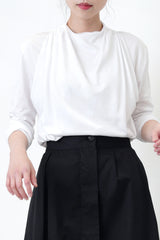 White blouse in drape layering detail