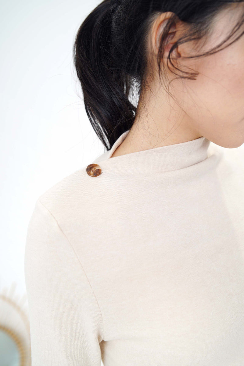 Nude cotton top in asymmetric collar