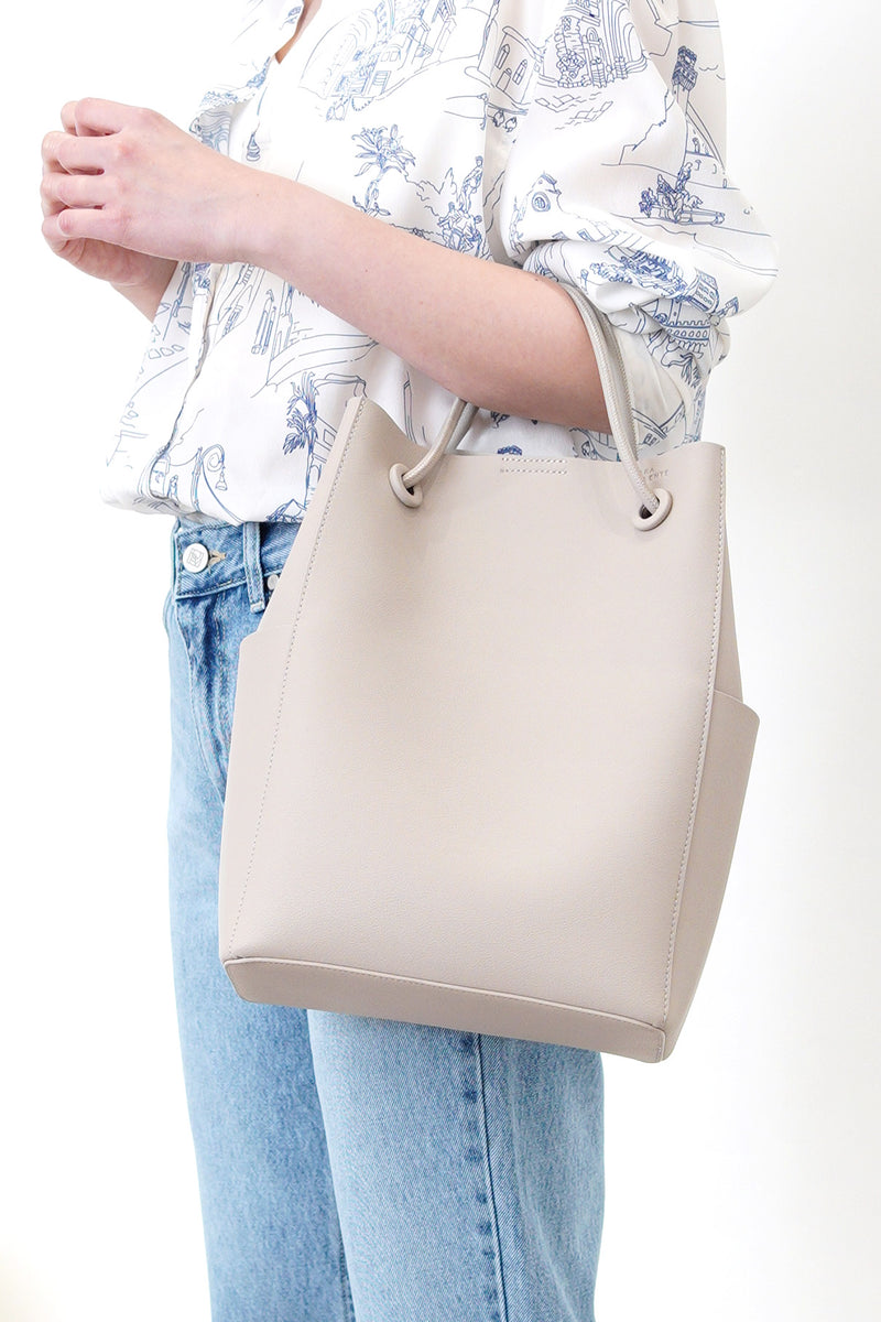 Grey leather tote in round thin strap